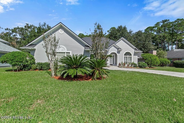 view of front of property with a garage and a front yard