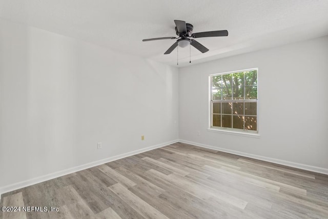 spare room featuring ceiling fan and light hardwood / wood-style flooring