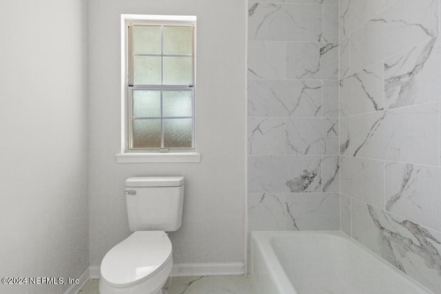 bathroom featuring toilet and a tub