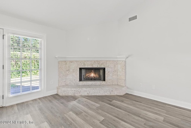 unfurnished living room with hardwood / wood-style floors and a fireplace