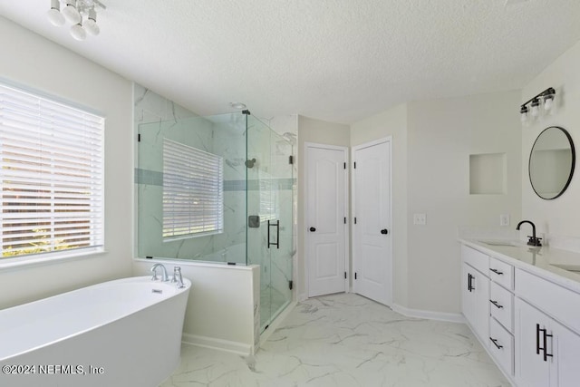 bathroom with shower with separate bathtub, vanity, and a textured ceiling