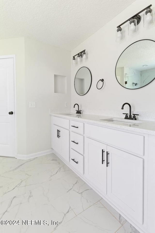 bathroom featuring vanity and a textured ceiling