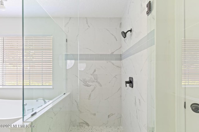 bathroom featuring separate shower and tub