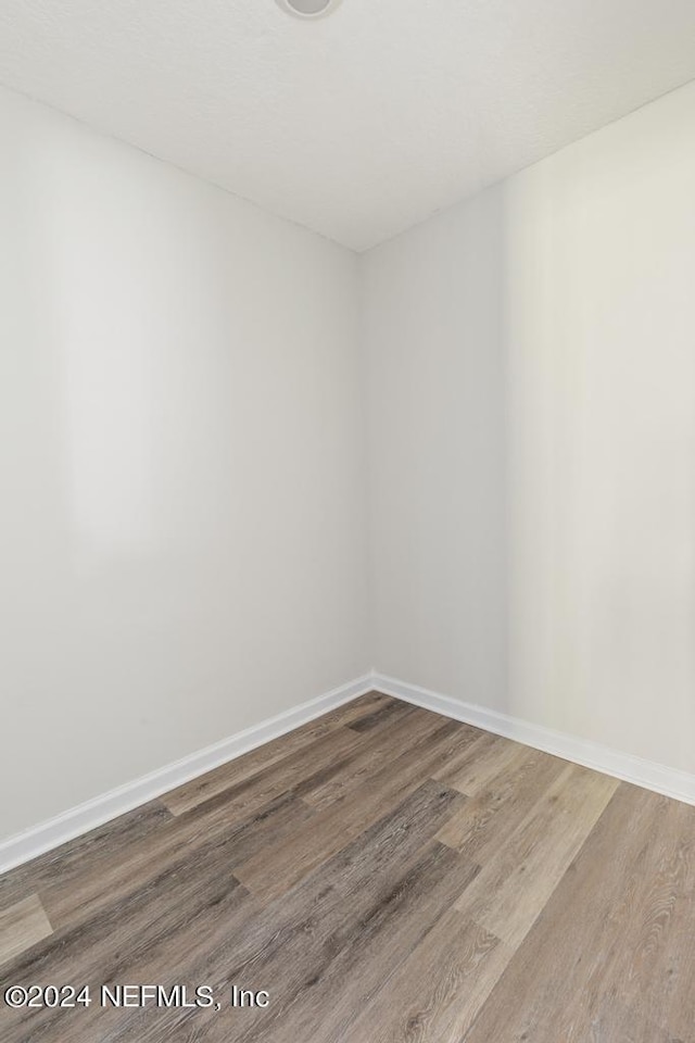 spare room with hardwood / wood-style flooring