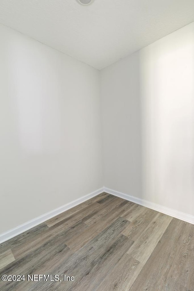 spare room with hardwood / wood-style flooring