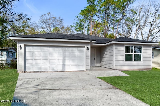 ranch-style home with a garage and a front yard