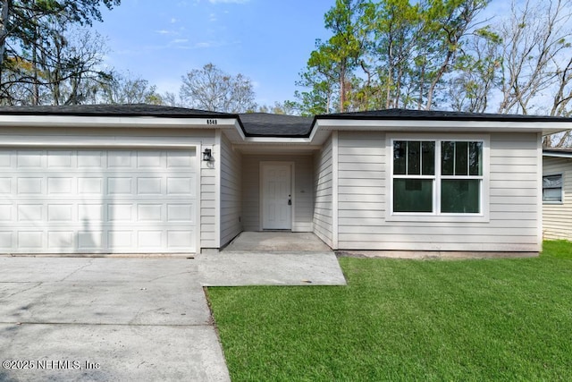 ranch-style house with a garage and a front yard