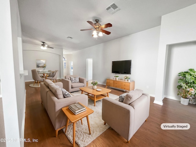 living room with wood-type flooring and ceiling fan