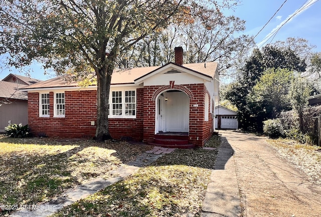 view of front facade featuring a garage and an outbuilding