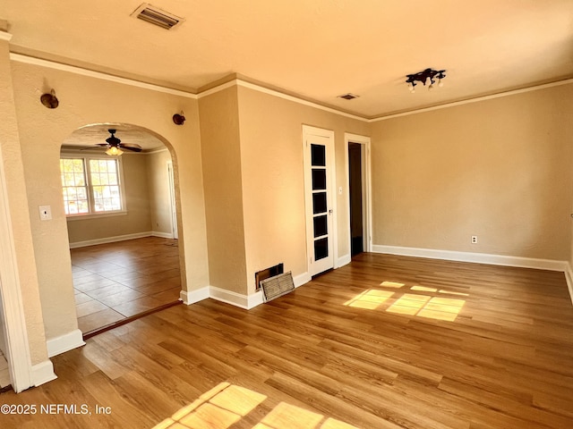 spare room featuring crown molding, ceiling fan, and wood-type flooring