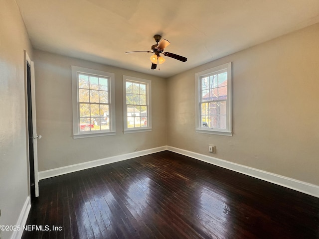 unfurnished room with ceiling fan and dark hardwood / wood-style flooring
