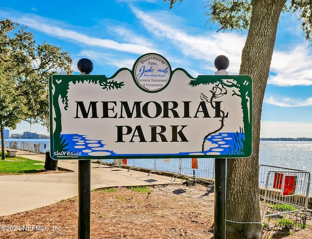 community / neighborhood sign with a water view