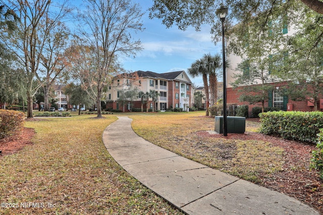 view of home's community with a lawn