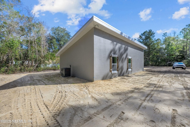 view of side of home with central air condition unit