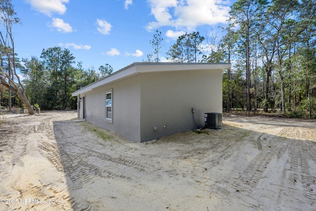 view of side of home featuring central AC