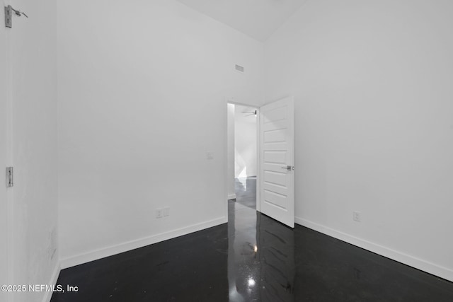 unfurnished bedroom with a towering ceiling