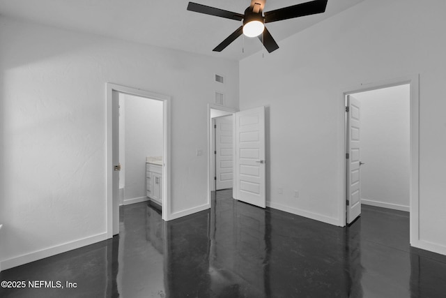 unfurnished bedroom featuring connected bathroom, a spacious closet, vaulted ceiling, and ceiling fan