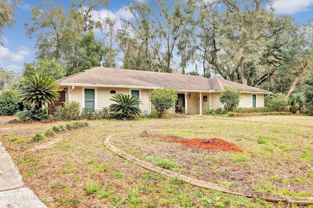 ranch-style home featuring a front yard