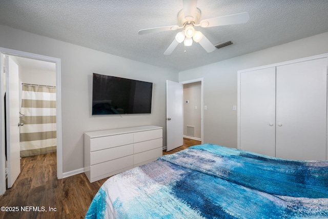 bedroom featuring ceiling fan, dark hardwood / wood-style flooring, a closet, and a textured ceiling