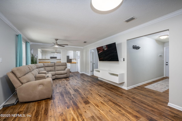 living room with dark hardwood / wood-style flooring, ceiling fan, crown molding, and a textured ceiling