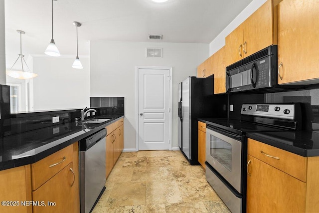 kitchen with appliances with stainless steel finishes, sink, and decorative light fixtures