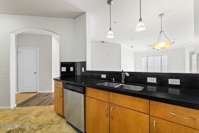 kitchen with crown molding, pendant lighting, sink, and stainless steel dishwasher