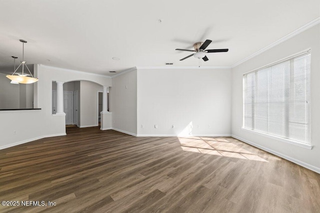 unfurnished living room featuring crown molding, dark wood-type flooring, decorative columns, and ceiling fan