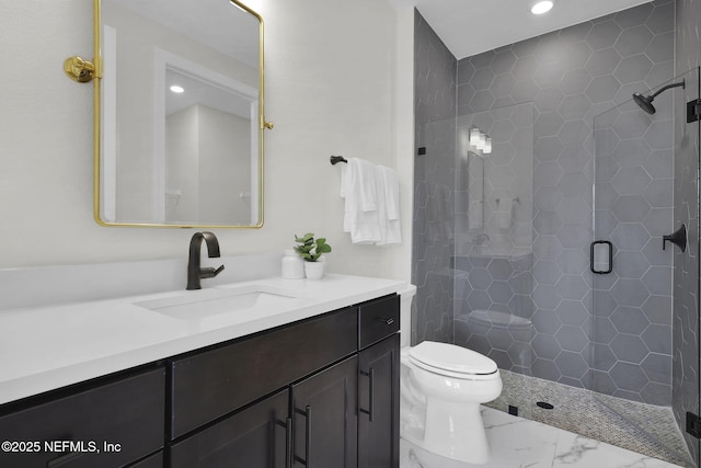 bathroom with vanity, toilet, and a shower with door