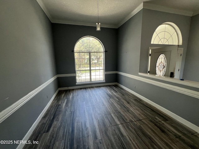 unfurnished dining area featuring ornamental molding, a textured ceiling, and dark hardwood / wood-style flooring