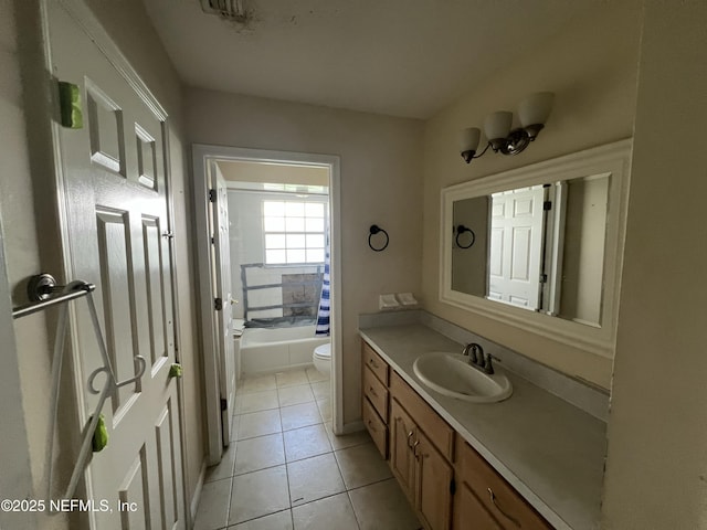 full bathroom with vanity, tile patterned floors, washtub / shower combination, and toilet