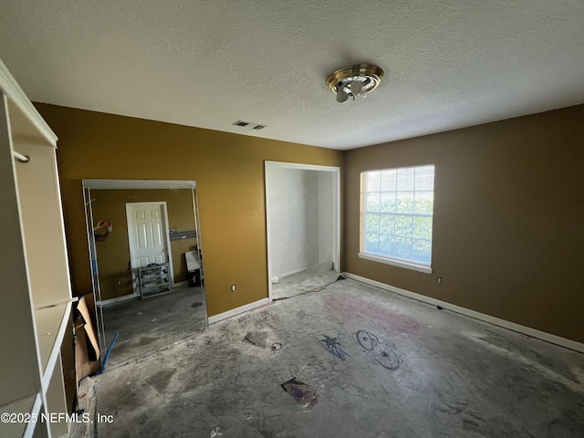 unfurnished bedroom featuring a textured ceiling