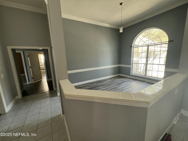 interior space featuring crown molding and a textured ceiling