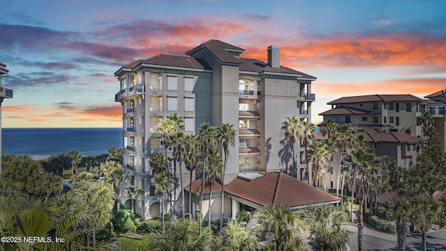 outdoor building at dusk featuring a water view