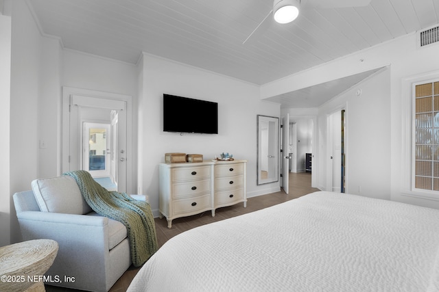 bedroom with dark hardwood / wood-style flooring, wood ceiling, and ornamental molding