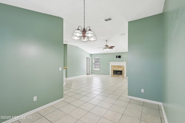 unfurnished living room with ceiling fan with notable chandelier, a tile fireplace, and light tile patterned floors