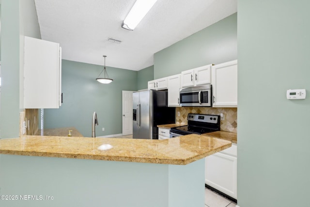 kitchen with appliances with stainless steel finishes, decorative light fixtures, kitchen peninsula, and white cabinets