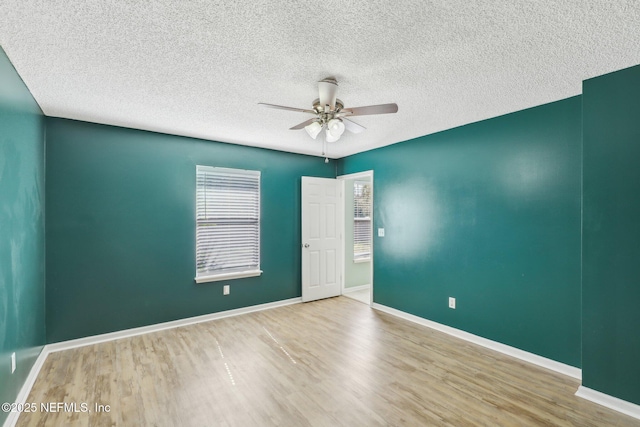 unfurnished room with hardwood / wood-style floors, a textured ceiling, and ceiling fan