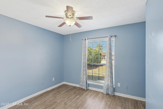 empty room with hardwood / wood-style floors, a textured ceiling, and ceiling fan