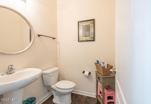 bathroom with sink, wood-type flooring, and toilet