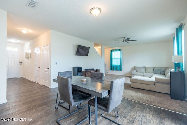 dining area with dark hardwood / wood-style floors and ceiling fan