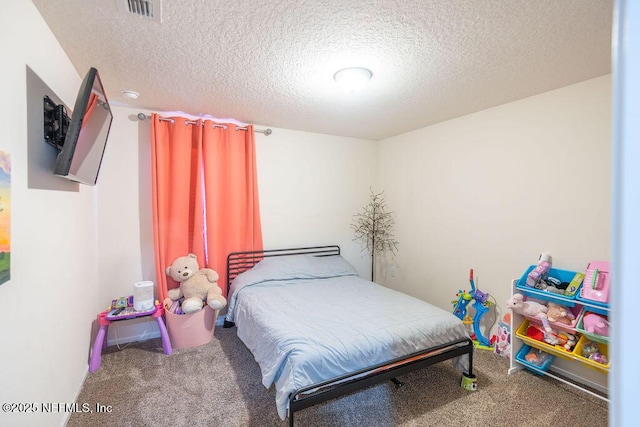 carpeted bedroom with a textured ceiling