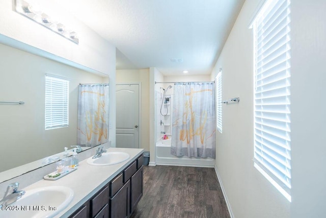 bathroom featuring shower / bathtub combination with curtain, hardwood / wood-style floors, and vanity