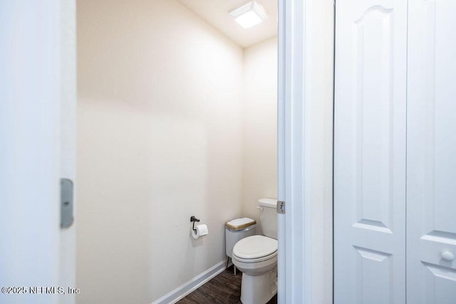 bathroom featuring hardwood / wood-style floors and toilet