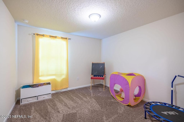 rec room with carpet floors and a textured ceiling