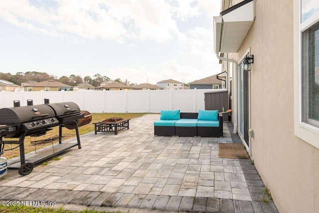 view of patio featuring an outdoor living space with a fire pit