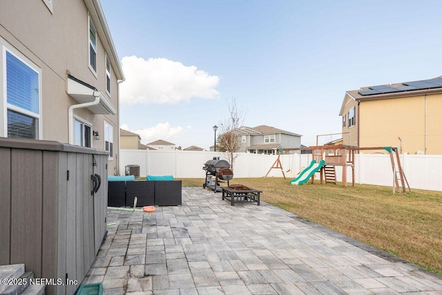 view of patio / terrace with cooling unit, area for grilling, a playground, and a fire pit