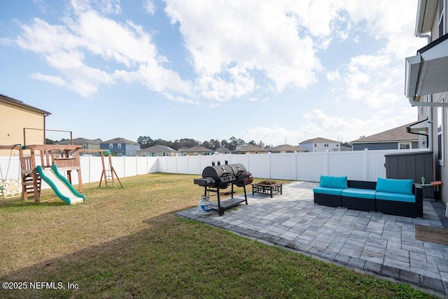 view of yard with a patio area, an outdoor living space with a fire pit, and a playground