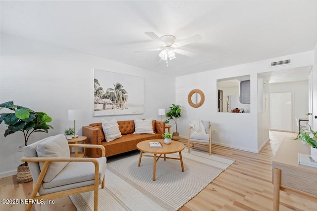 living room with ceiling fan and light hardwood / wood-style flooring