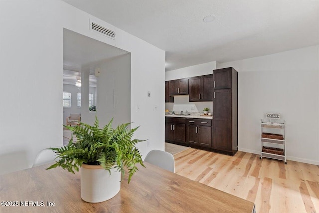 dining space featuring sink and light wood-type flooring