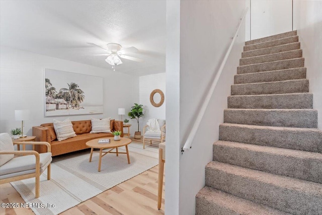 living room with hardwood / wood-style flooring and ceiling fan